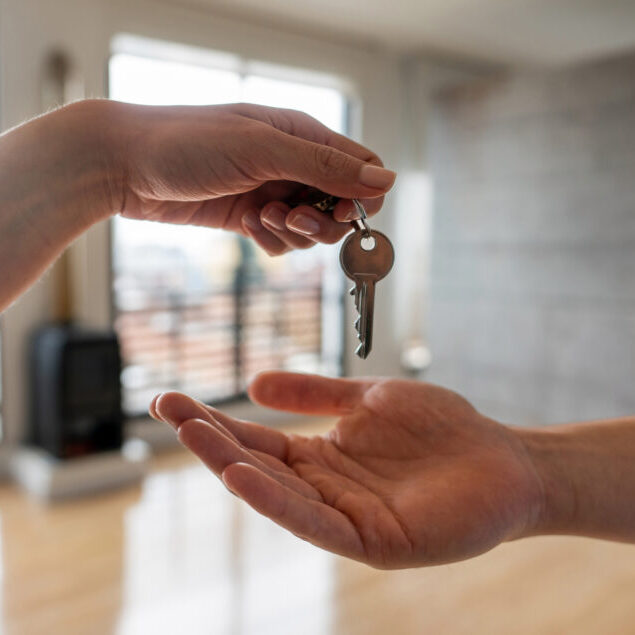 Real estate agent giving the keys of his new house to a man
